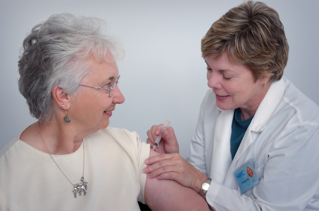 how-it-works In this 2006 image, a qualified healthcare practitioner was in the process of administering an intramuscular immunization to a middle-aged woman, using the woman’s left shoulder muscle as the injection site. The practitioner immobilized the injection area with her free hand.